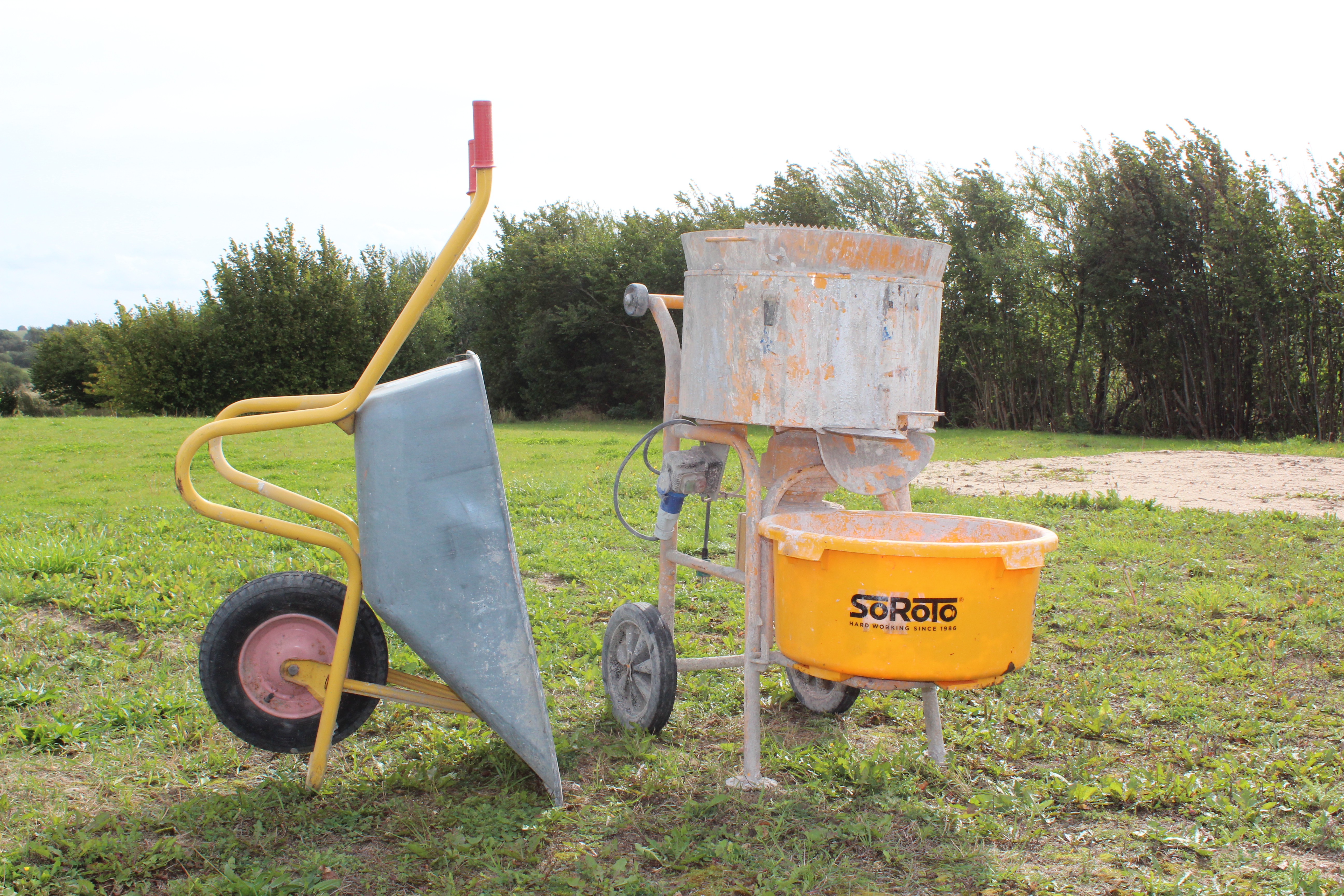 Eight shirts arranged on table in black, olive, grey, blue, white, red, mustard, and green.