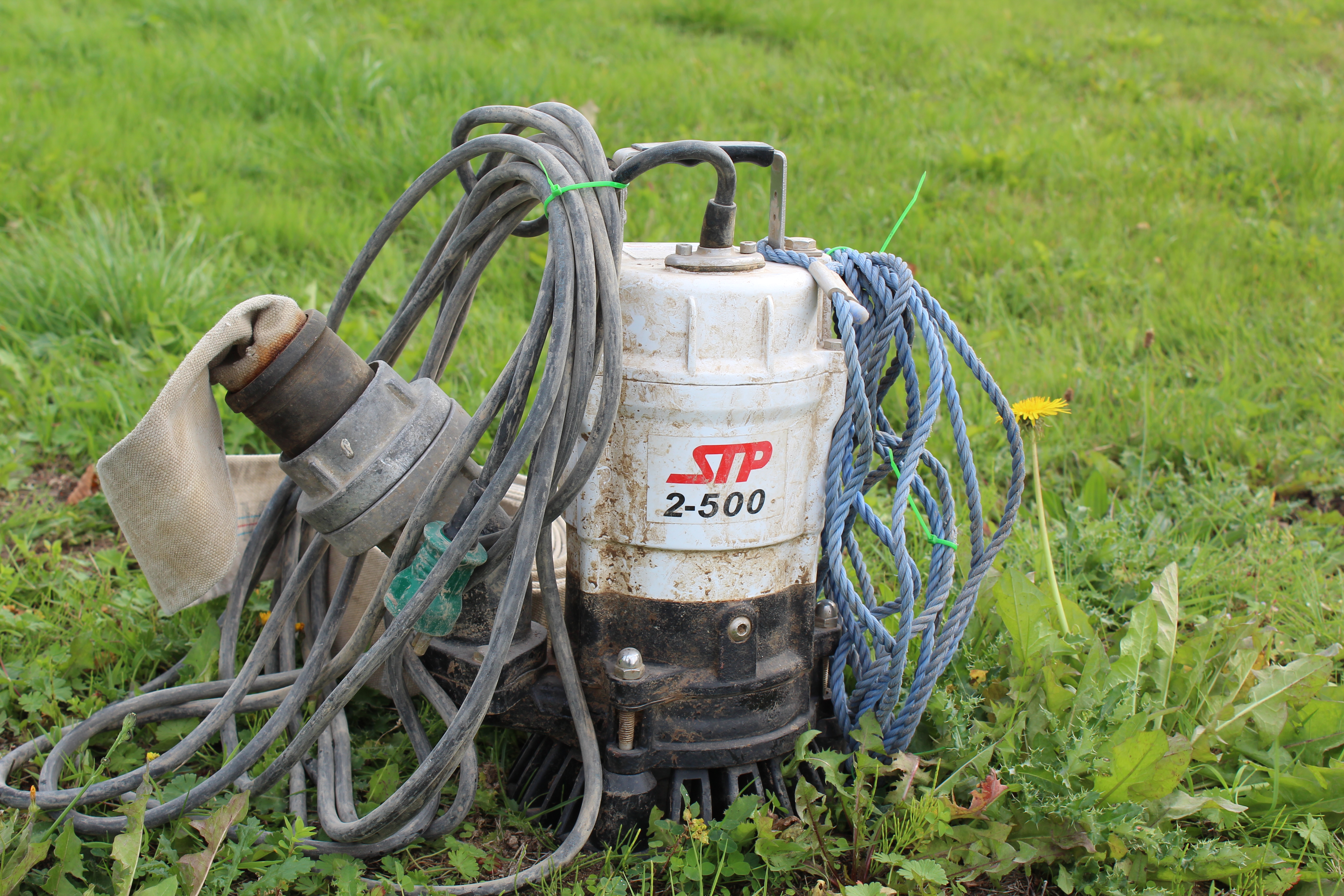 Eight shirts arranged on table in black, olive, grey, blue, white, red, mustard, and green.