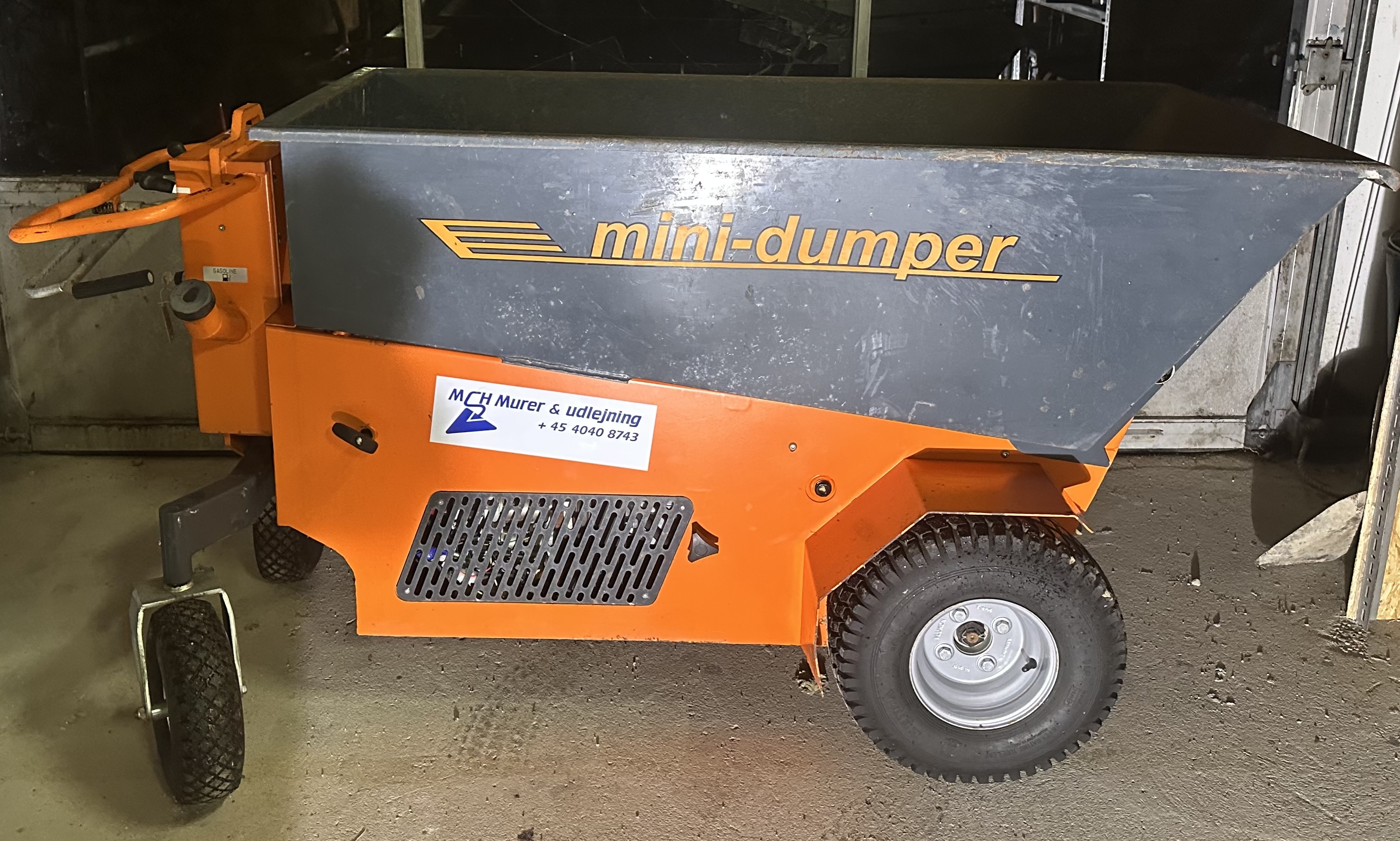 Eight shirts arranged on table in black, olive, grey, blue, white, red, mustard, and green.