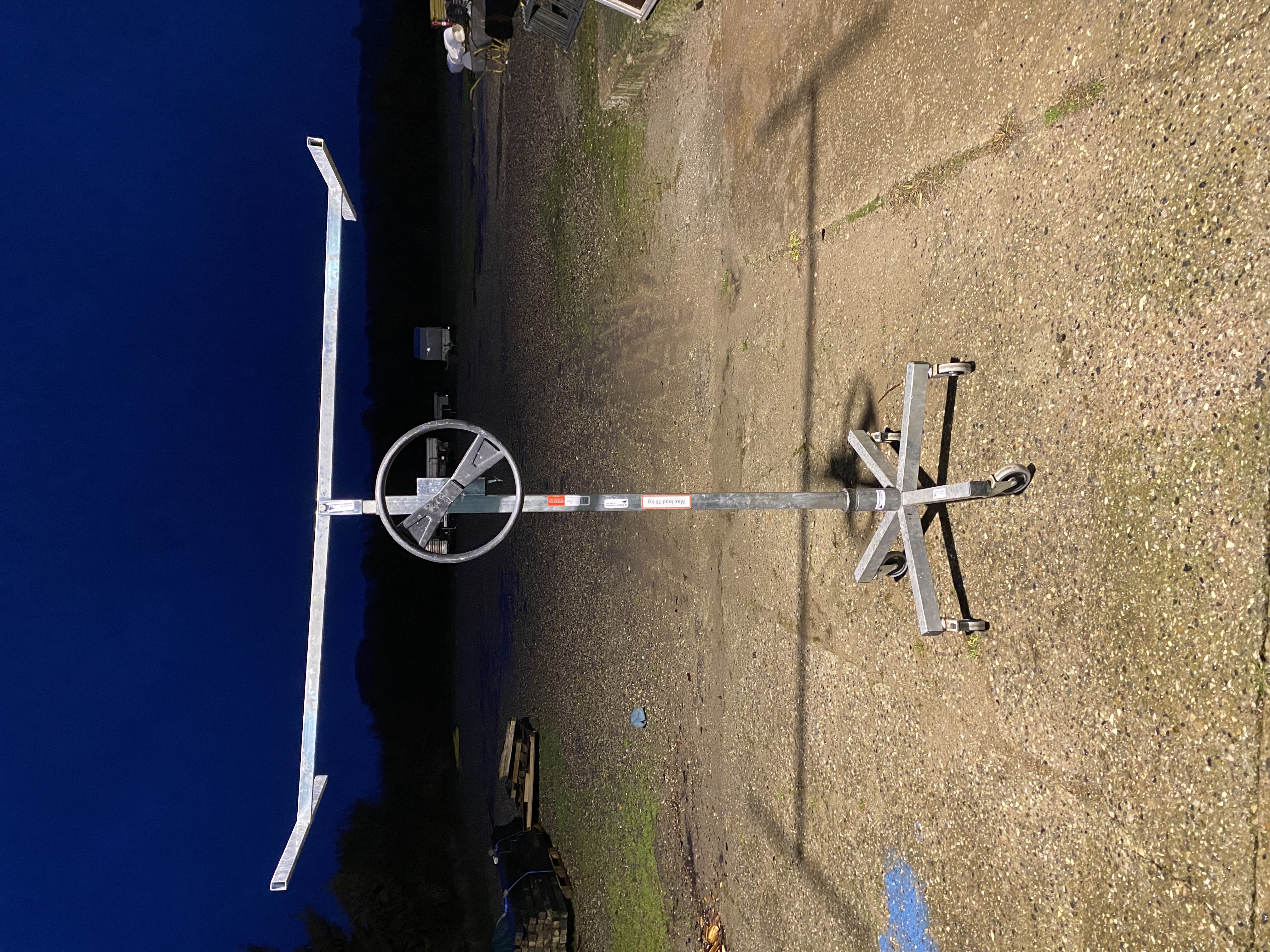 Eight shirts arranged on table in black, olive, grey, blue, white, red, mustard, and green.