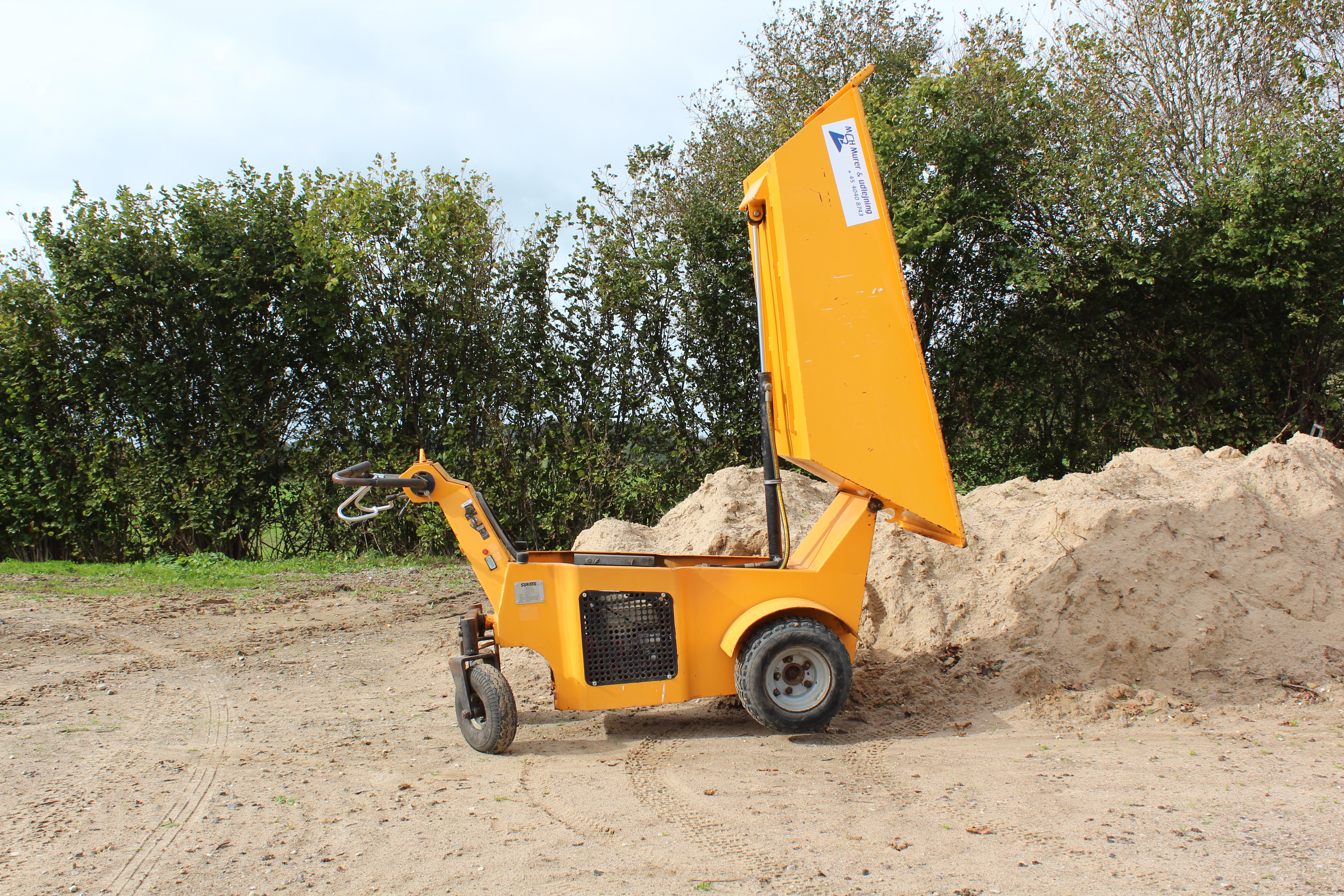 Eight shirts arranged on table in black, olive, grey, blue, white, red, mustard, and green.