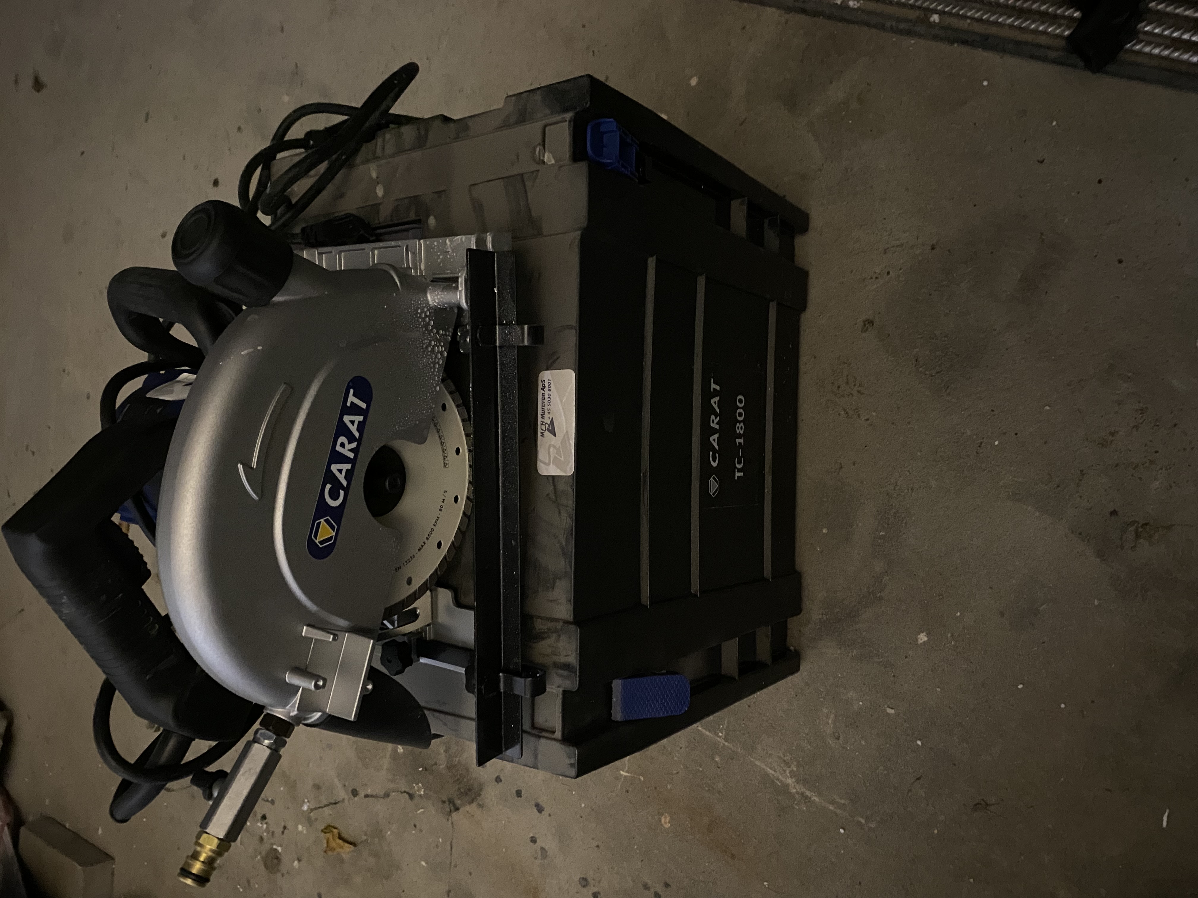 Eight shirts arranged on table in black, olive, grey, blue, white, red, mustard, and green.