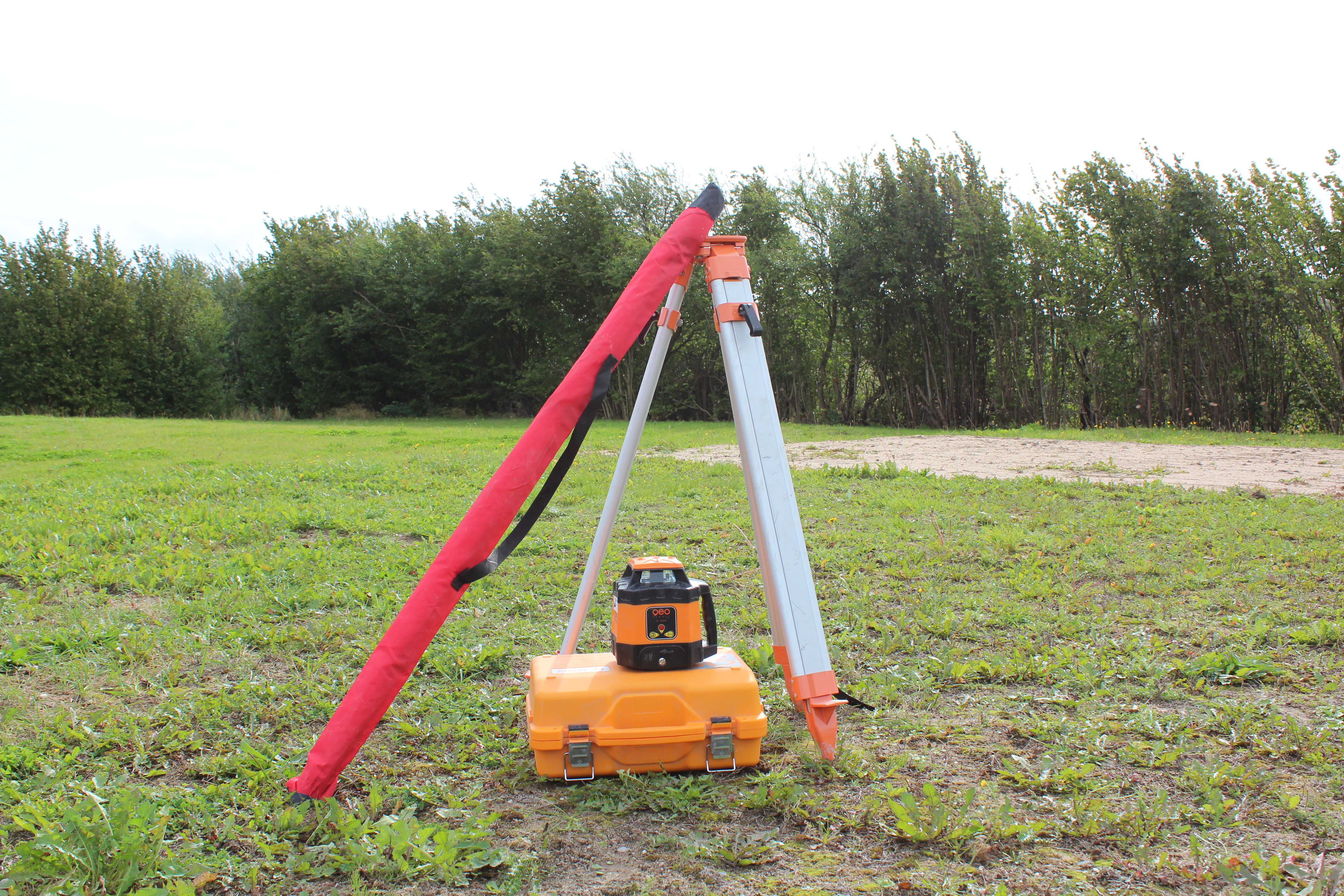 Eight shirts arranged on table in black, olive, grey, blue, white, red, mustard, and green.