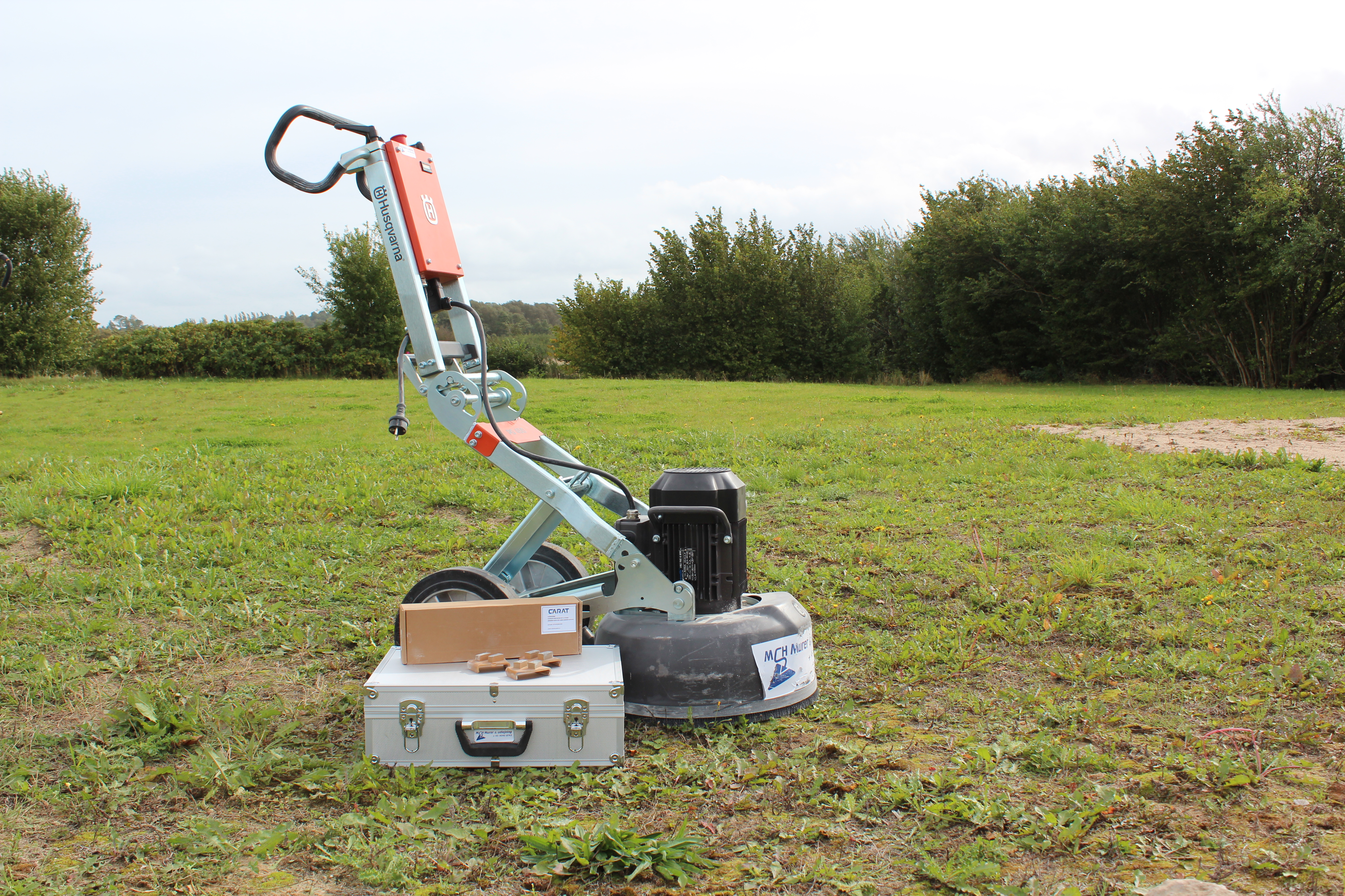 Eight shirts arranged on table in black, olive, grey, blue, white, red, mustard, and green.