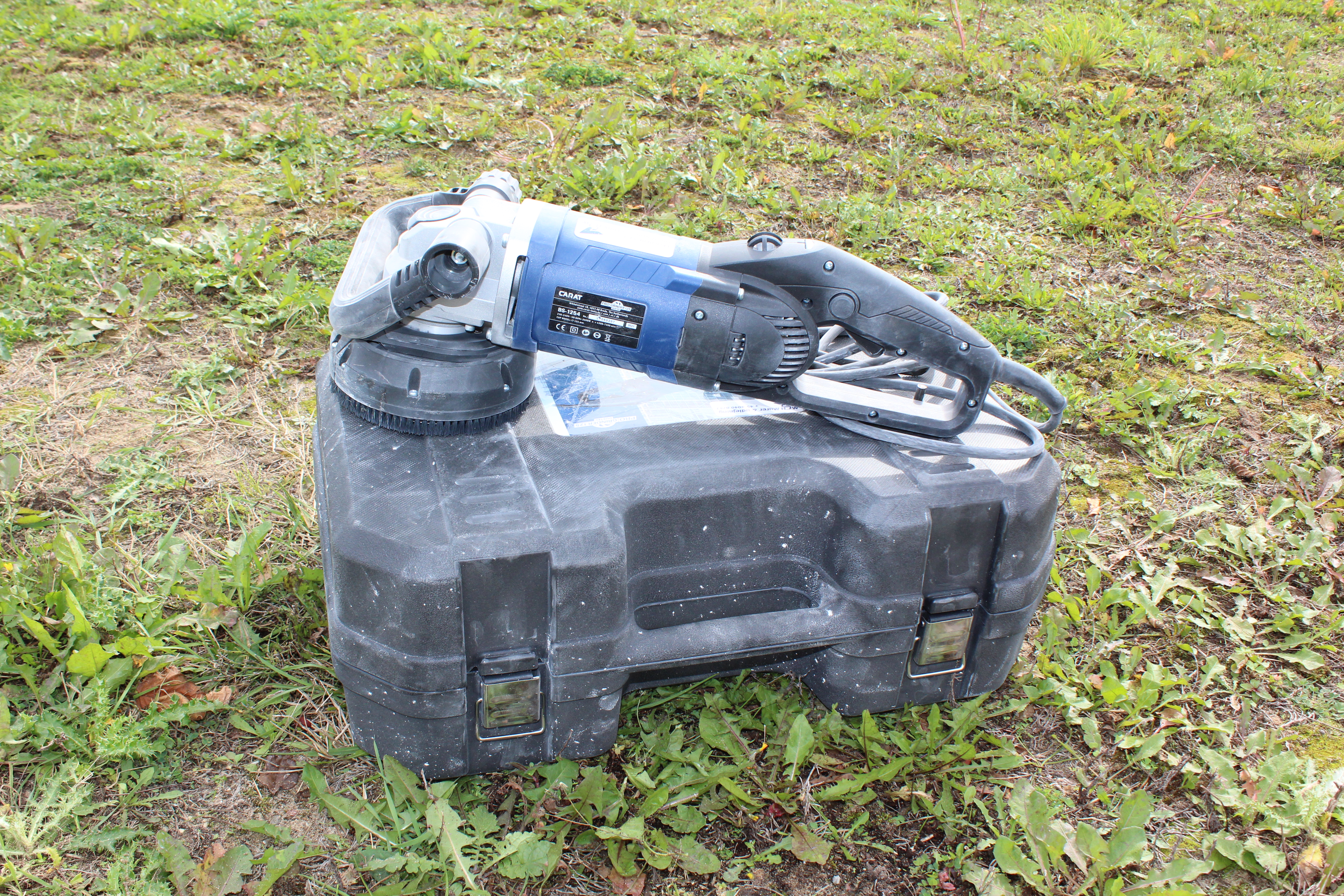 Eight shirts arranged on table in black, olive, grey, blue, white, red, mustard, and green.