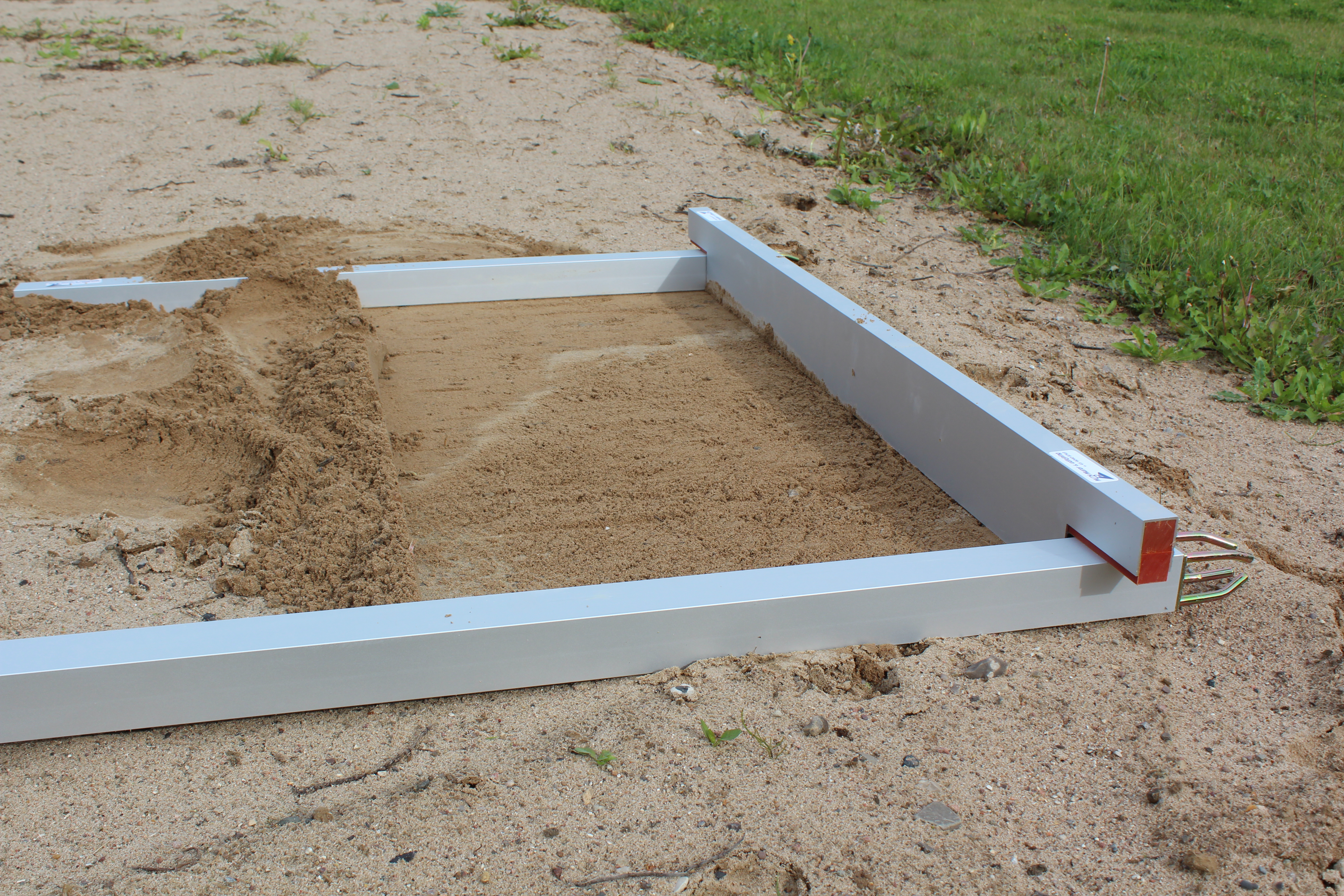 Eight shirts arranged on table in black, olive, grey, blue, white, red, mustard, and green.