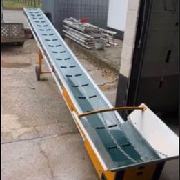 Eight shirts arranged on table in black, olive, grey, blue, white, red, mustard, and green.