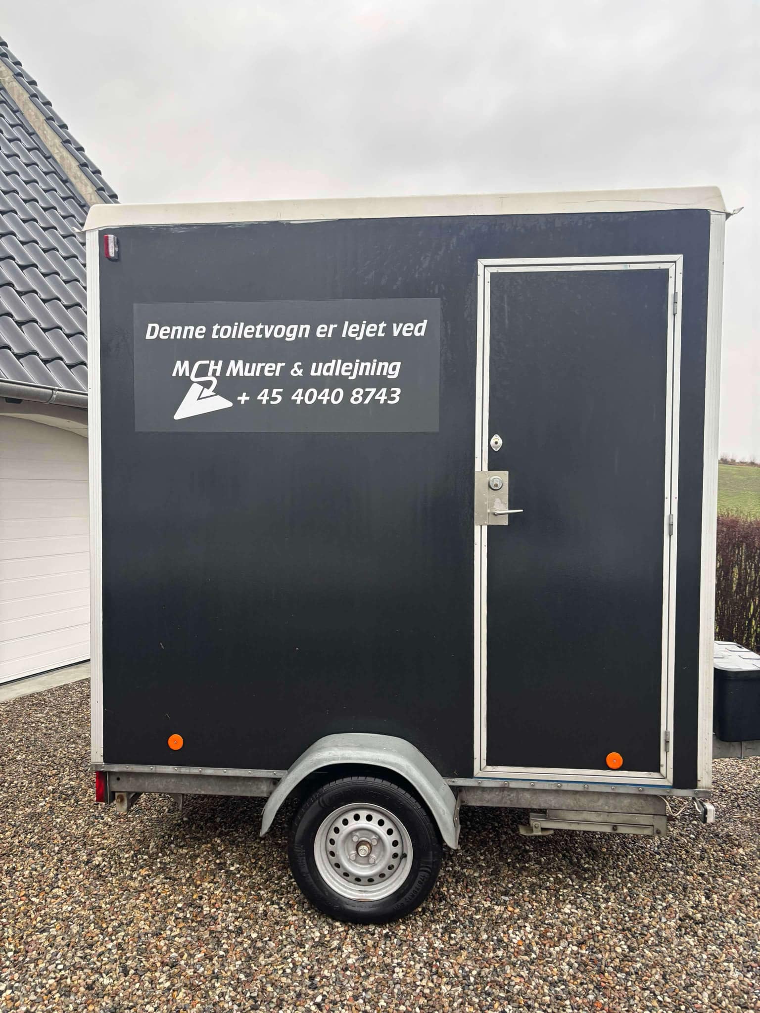 Eight shirts arranged on table in black, olive, grey, blue, white, red, mustard, and green.